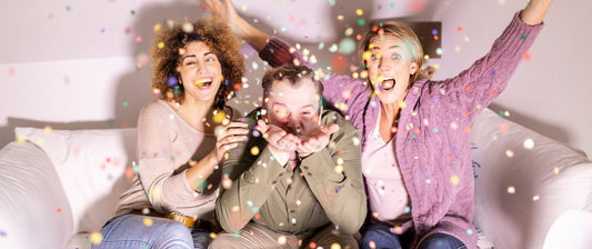 people on a couch throwing confetti, so excited about our most popular couch collections